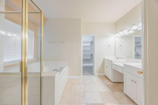 bathroom with independent shower and bath, vanity, and tile patterned flooring