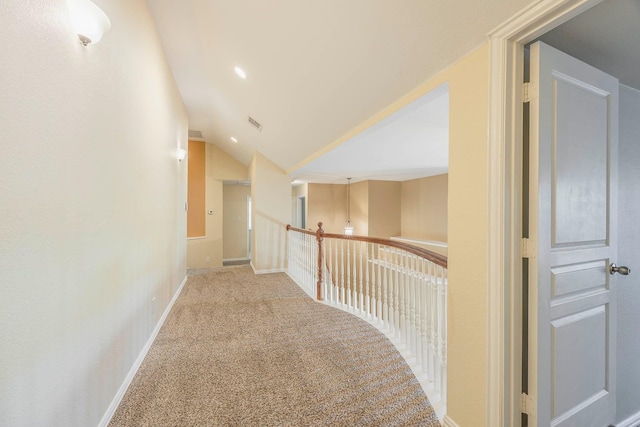 hall with vaulted ceiling and carpet