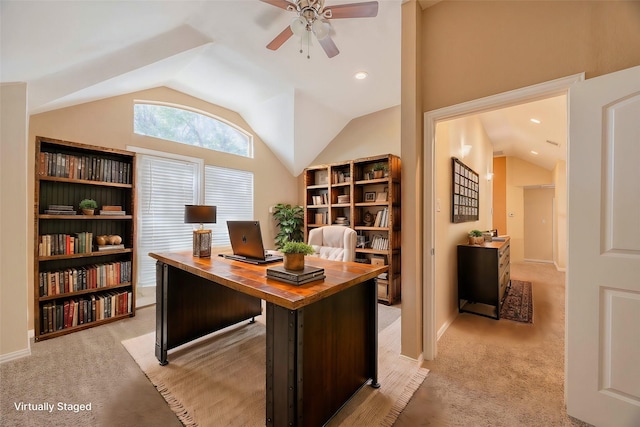 carpeted office space featuring vaulted ceiling and ceiling fan