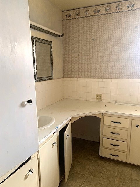 807 N Morris Ave, Rotan, TX 79546 - unfurnished office with dark tile patterned floors and a sink