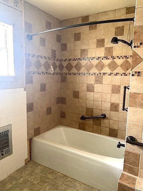 bathroom featuring tiled shower / bath and tile patterned flooring