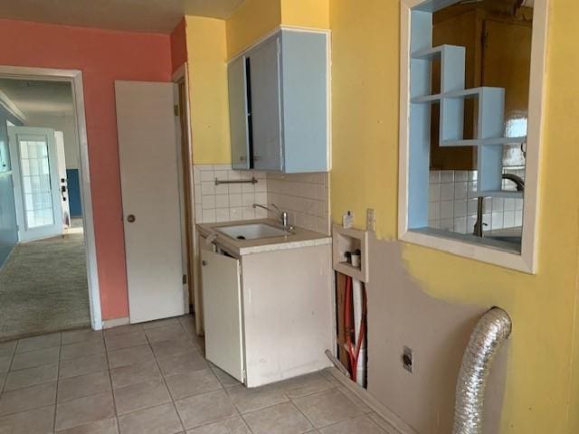 807 N Morris Ave, Rotan, TX 79546 - laundry area with hookup for an electric dryer, cabinet space, and light tile patterned floors