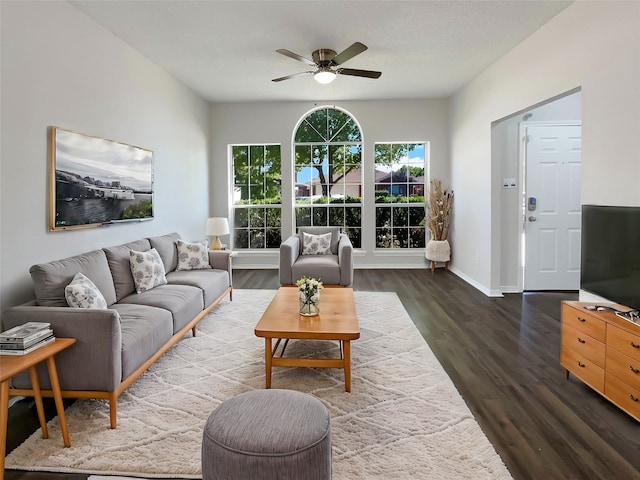 living room with ceiling fan, a textured ceiling, and dark hardwood / wood-style flooring