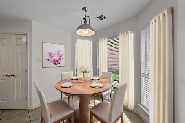 dining area with light tile patterned floors