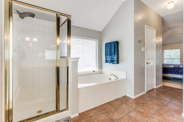 bathroom featuring separate shower and tub, lofted ceiling, and tile patterned floors