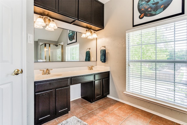 bathroom with vanity, lofted ceiling, a shower with shower door, and tile patterned floors