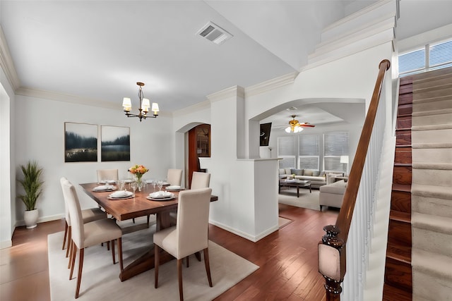 dining room featuring crown molding, ceiling fan with notable chandelier, wood-type flooring, and a healthy amount of sunlight