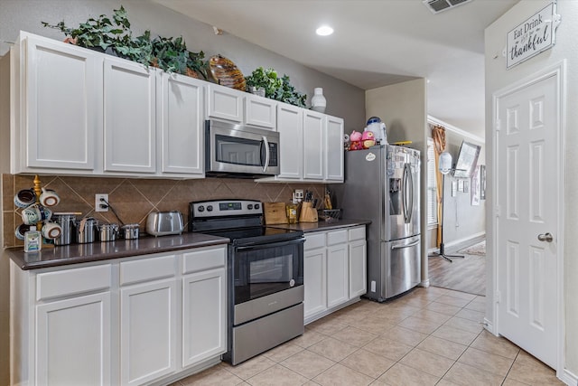 kitchen with white cabinetry, appliances with stainless steel finishes, and light tile patterned flooring