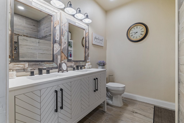 bathroom with tasteful backsplash, wood-type flooring, toilet, tiled shower, and vanity