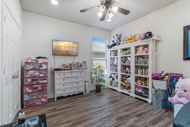 recreation room with ceiling fan and dark hardwood / wood-style flooring