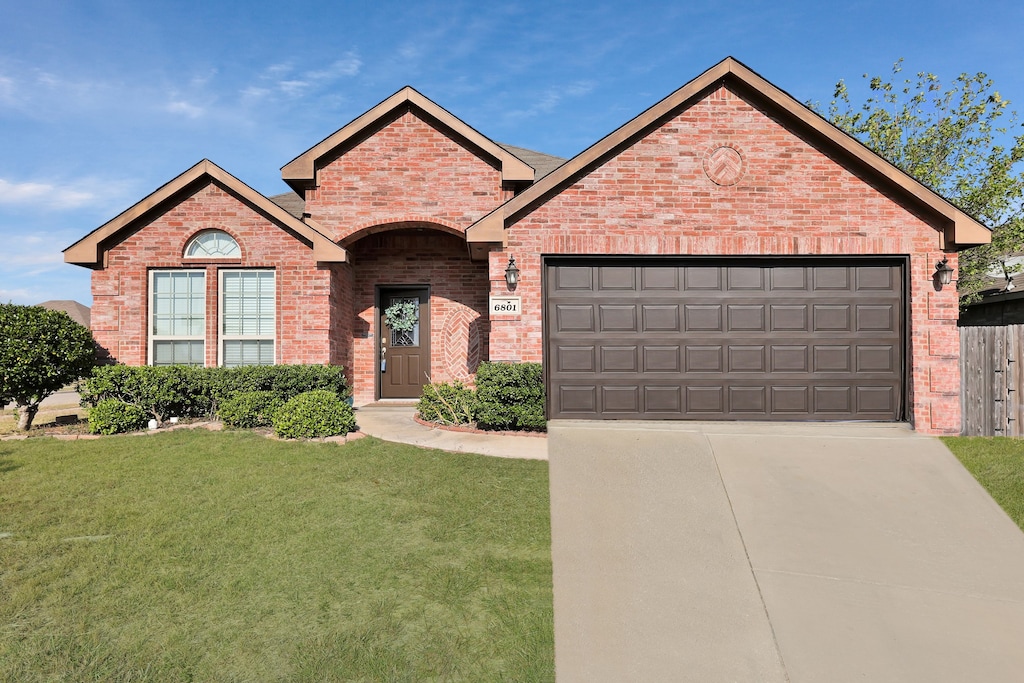 view of front of property with a front lawn and a garage