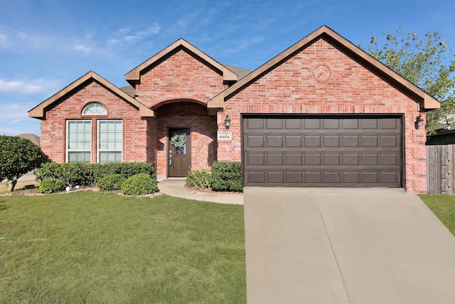 view of front of property with a front lawn and a garage