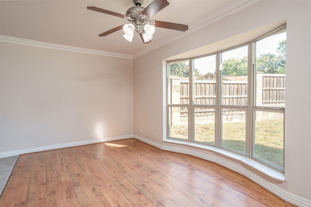 spare room featuring light hardwood / wood-style floors, crown molding, plenty of natural light, and ceiling fan