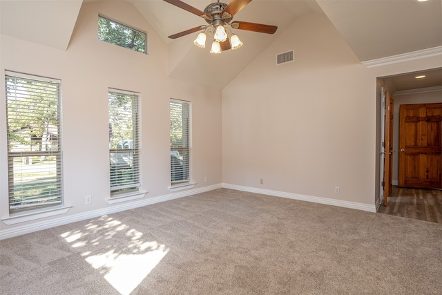 spare room with ornamental molding, high vaulted ceiling, carpet flooring, and ceiling fan