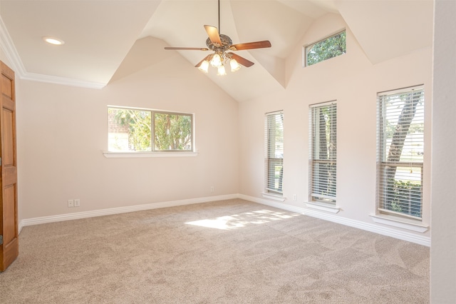 carpeted empty room with lofted ceiling, ornamental molding, and ceiling fan