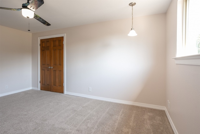 unfurnished room featuring carpet and ceiling fan