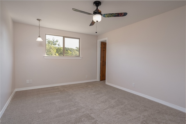 carpeted empty room featuring ceiling fan