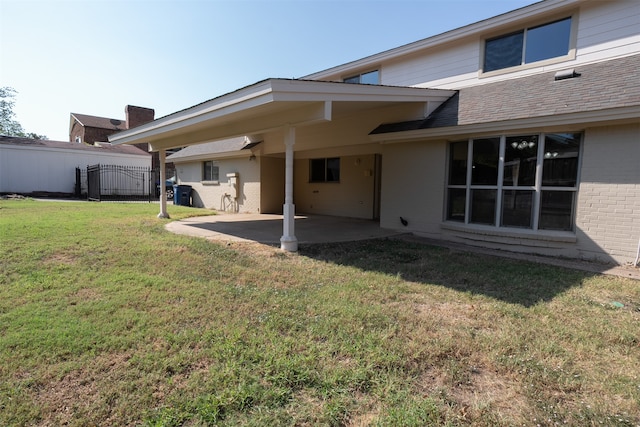 rear view of property featuring a patio and a lawn