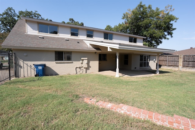 rear view of property featuring a patio and a lawn