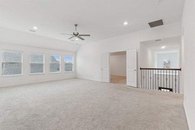 carpeted empty room featuring lofted ceiling and ceiling fan