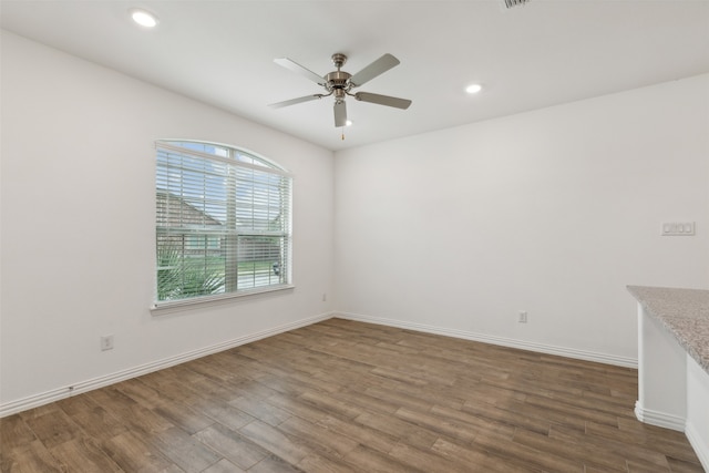 empty room featuring wood-type flooring and ceiling fan