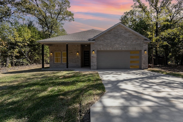 view of front of house with a garage and a lawn