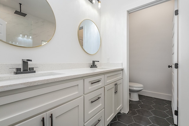 bathroom with toilet, walk in shower, vanity, and tile patterned flooring