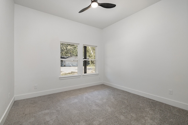 carpeted spare room with ceiling fan