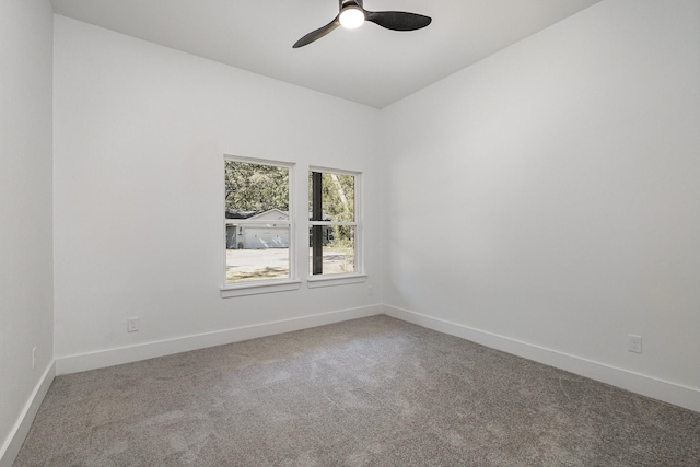 empty room featuring carpet flooring, a ceiling fan, and baseboards