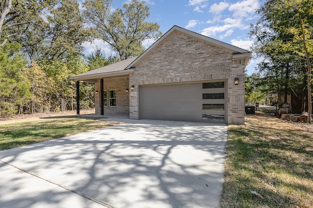 view of front of property with a garage and a front lawn