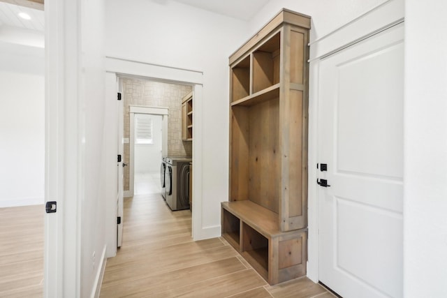 mudroom with separate washer and dryer and light hardwood / wood-style flooring