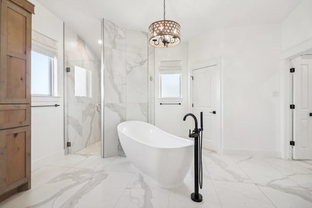 bathroom with separate shower and tub and a notable chandelier