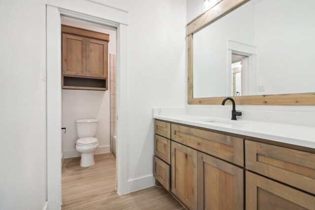 full bathroom with shower / bathing tub combination, vanity, toilet, and wood-type flooring