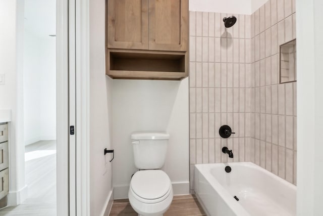 full bathroom with vanity, hardwood / wood-style flooring, toilet, and tiled shower / bath