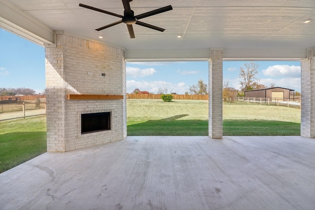 view of patio featuring an outdoor brick fireplace and ceiling fan