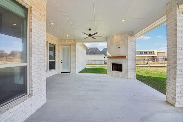 view of patio / terrace with an outdoor brick fireplace and ceiling fan