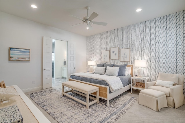 carpeted bedroom with ceiling fan and ensuite bathroom