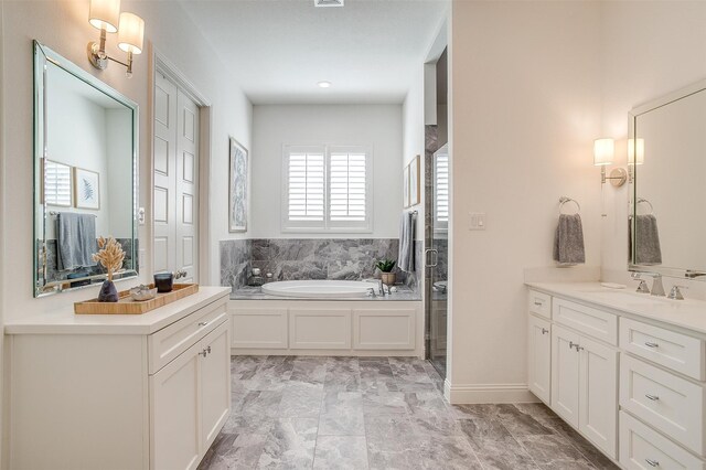 bathroom with vanity and a tub to relax in