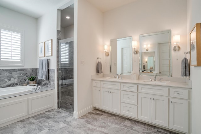 bathroom featuring vanity and shower with separate bathtub