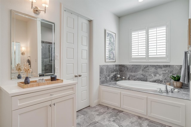 bathroom with vanity and shower with separate bathtub