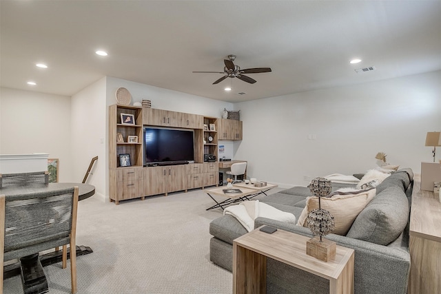 living room featuring ceiling fan and light colored carpet