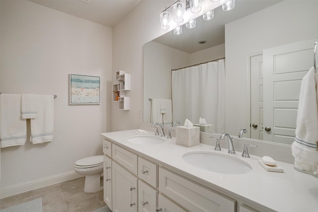 bathroom featuring vanity, toilet, and tile patterned flooring