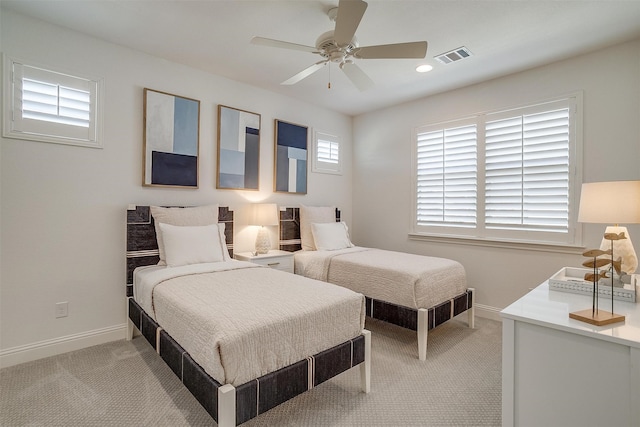 bedroom with ceiling fan and light colored carpet