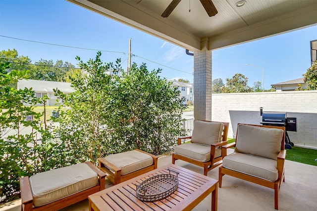 view of patio featuring ceiling fan and an outdoor fire pit