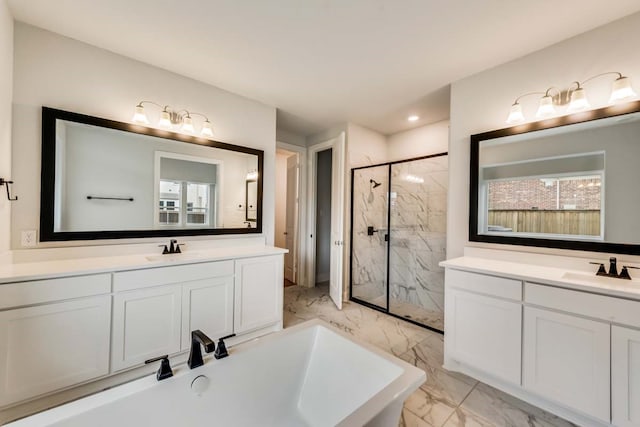 bathroom featuring vanity and independent shower and bath