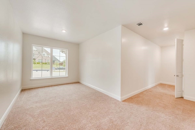 empty room featuring light carpet