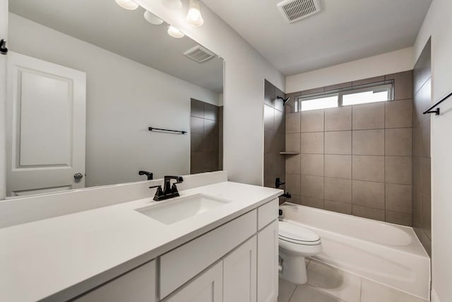 full bathroom with tiled shower / bath combo, vanity, tile patterned flooring, and toilet