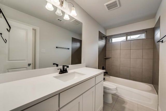 full bathroom featuring tile patterned flooring, vanity, toilet, and tiled shower / bath