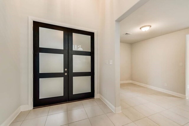 tiled entrance foyer with french doors