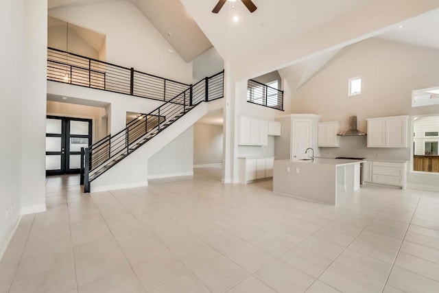 2802 Chandler Ct, Mansfield, TX 76063 - unfurnished living room featuring high vaulted ceiling, stairway, a ceiling fan, light tile patterned floors, and baseboards